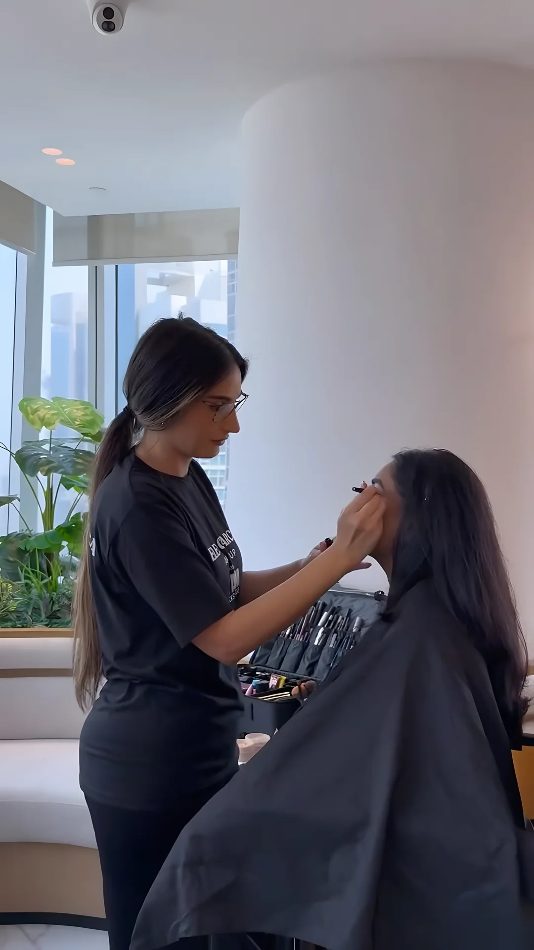 Elena applying makeup to a client